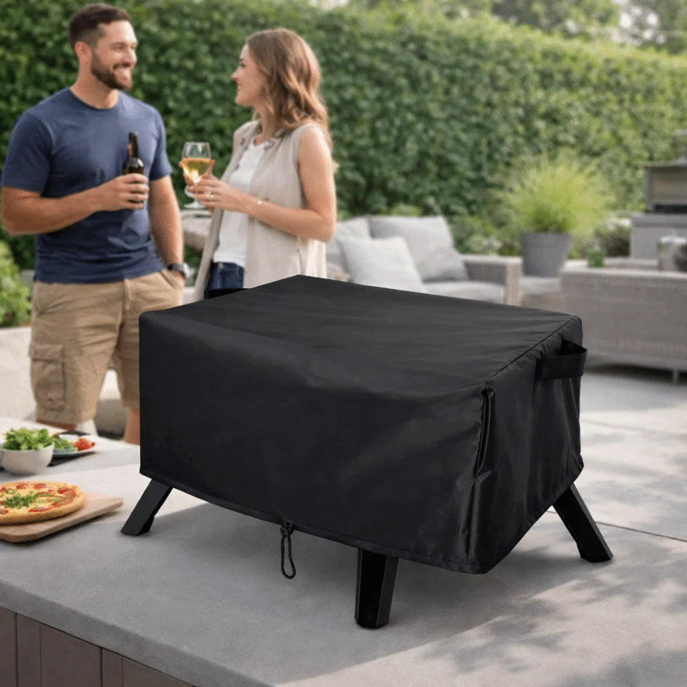 Black weatherproof cover on an outdoor pizza oven on a patio