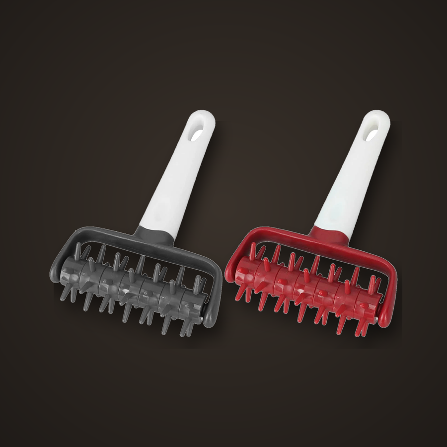 Pizza dough docker rollers in grey and red on a dark studio background